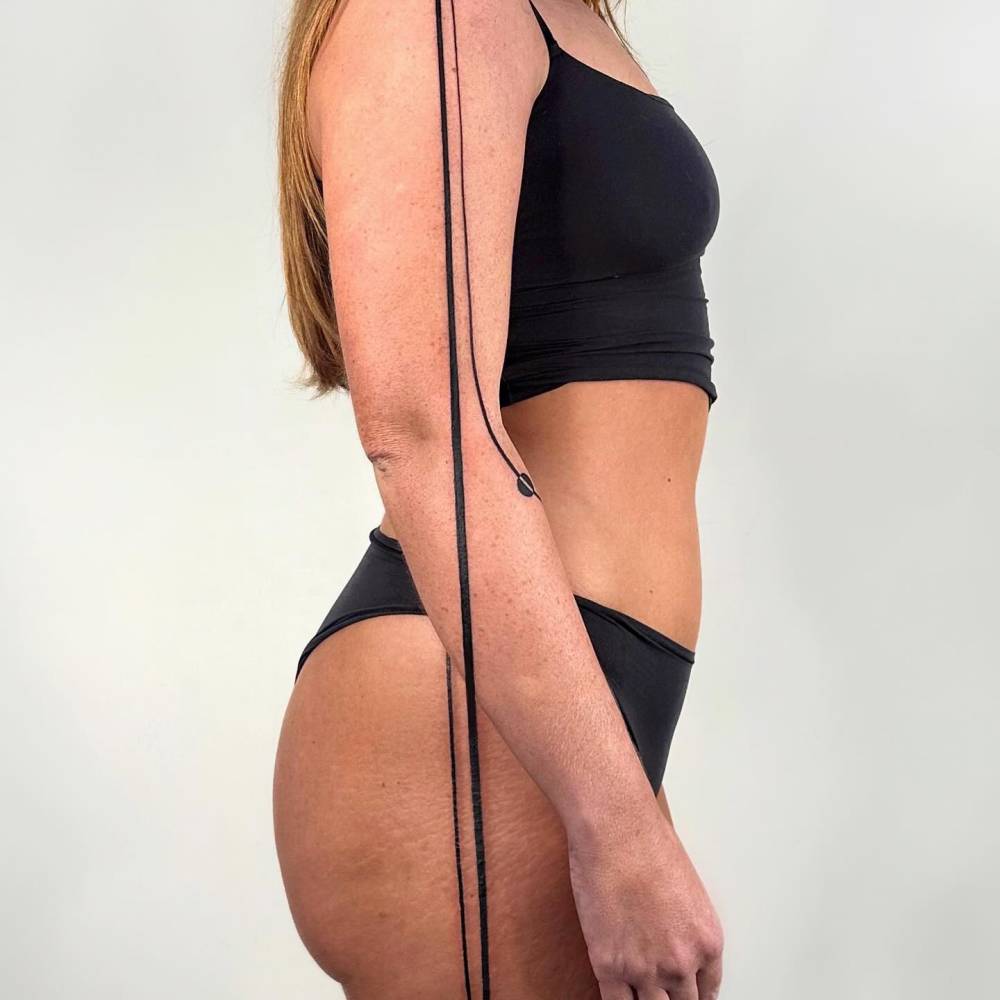 Lines tattooed in geometric style on the side of the body.