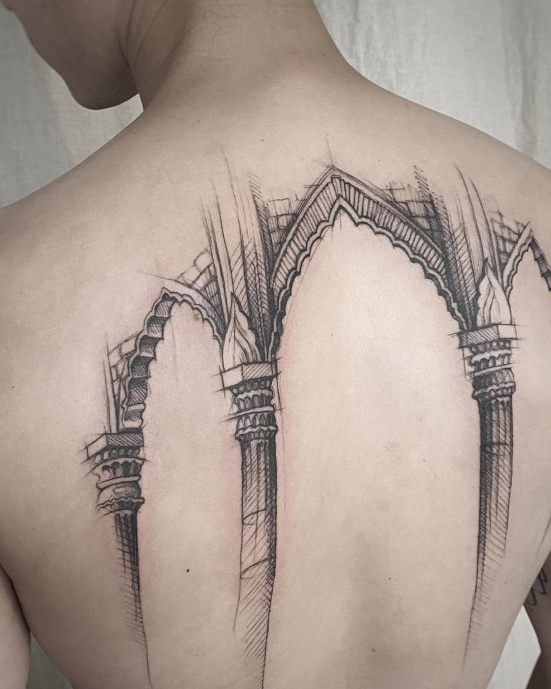 Sketch work style columns tattoo located on the upper back.