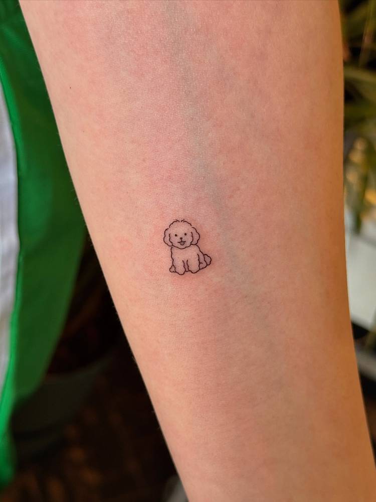 Tiny minimalistic Poodle tattoo located on the inner forearm.