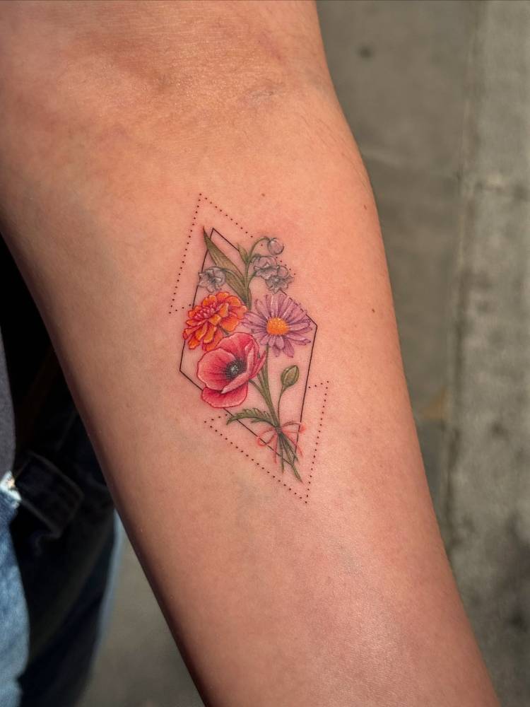 Illustrative style flower bouquet tattoo located on the inner forearm.