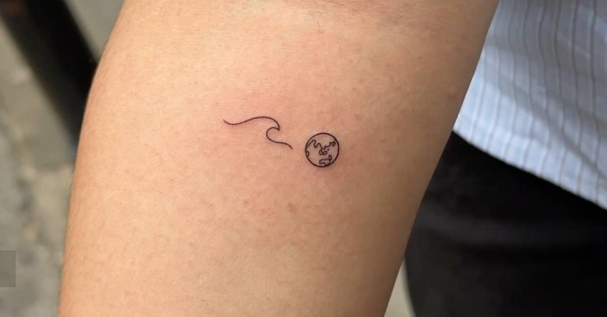 Minimalistic style wave and Earth tattoo located on the