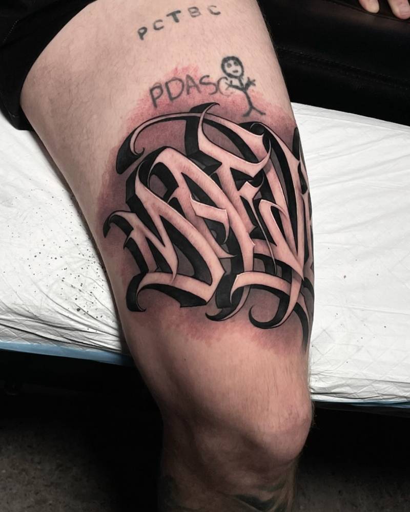 Lettering tattoo of the name "Maeve" located on the thigh.
