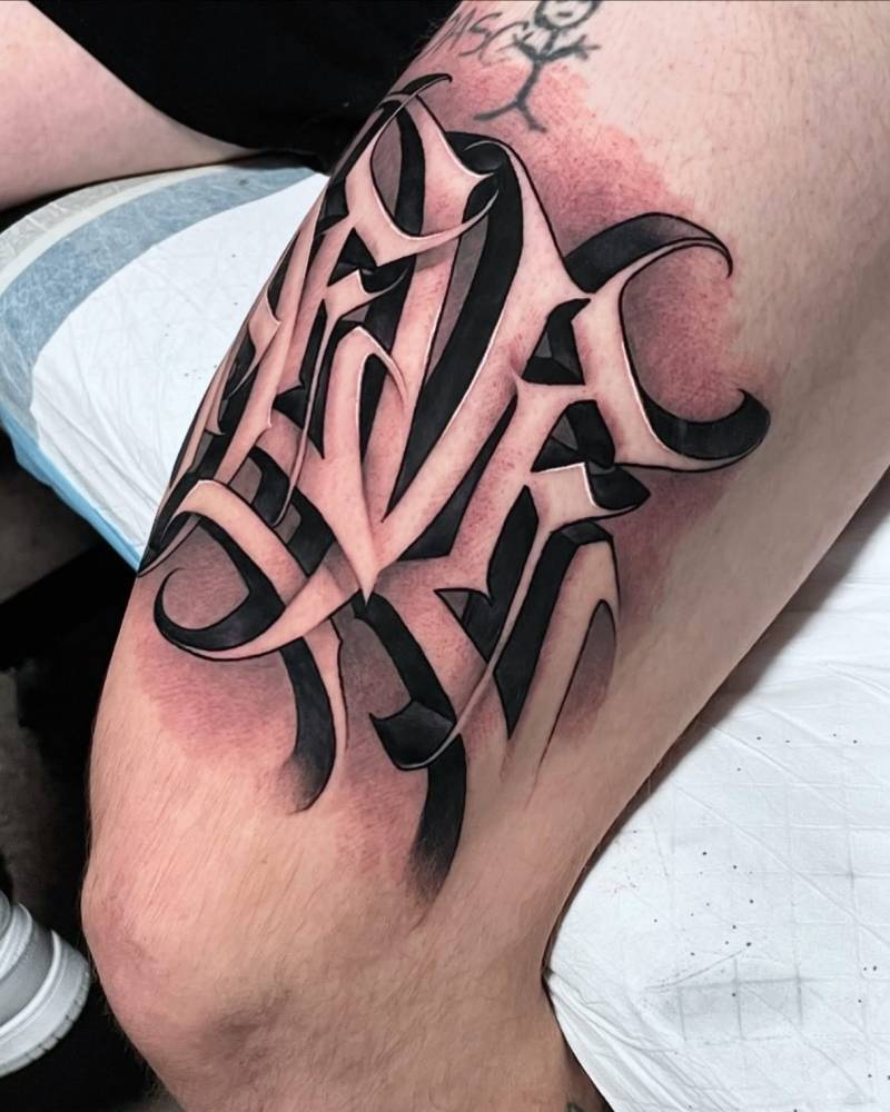 Lettering tattoo of the name "Maeve" located on the thigh.