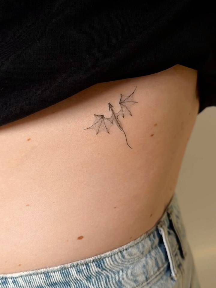 Dragon tattoo in illustrative style done on the rib.