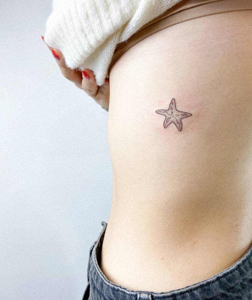 Starfish tattoo located on the rib, illustrative style.