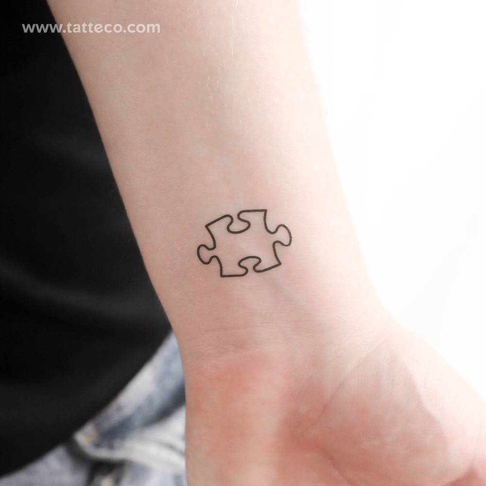 Puzzle piece temporary tattoo located on the wrist.