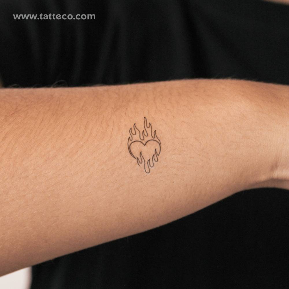 Flaming heart semi-permanent tattoo located on the wrist.