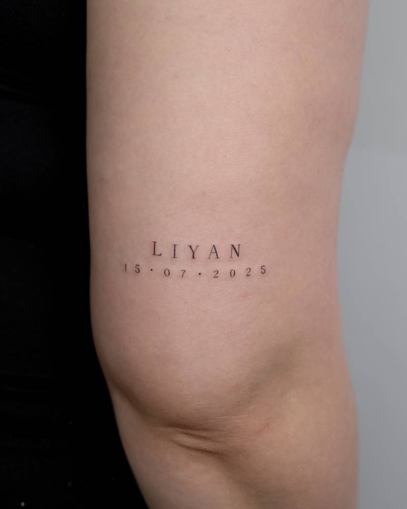 Name "Liyan" and birth date tattooed on the tricep.