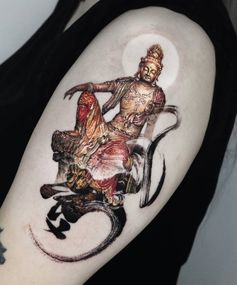 Buddha tattoo in micro-realism located on the upper arm.