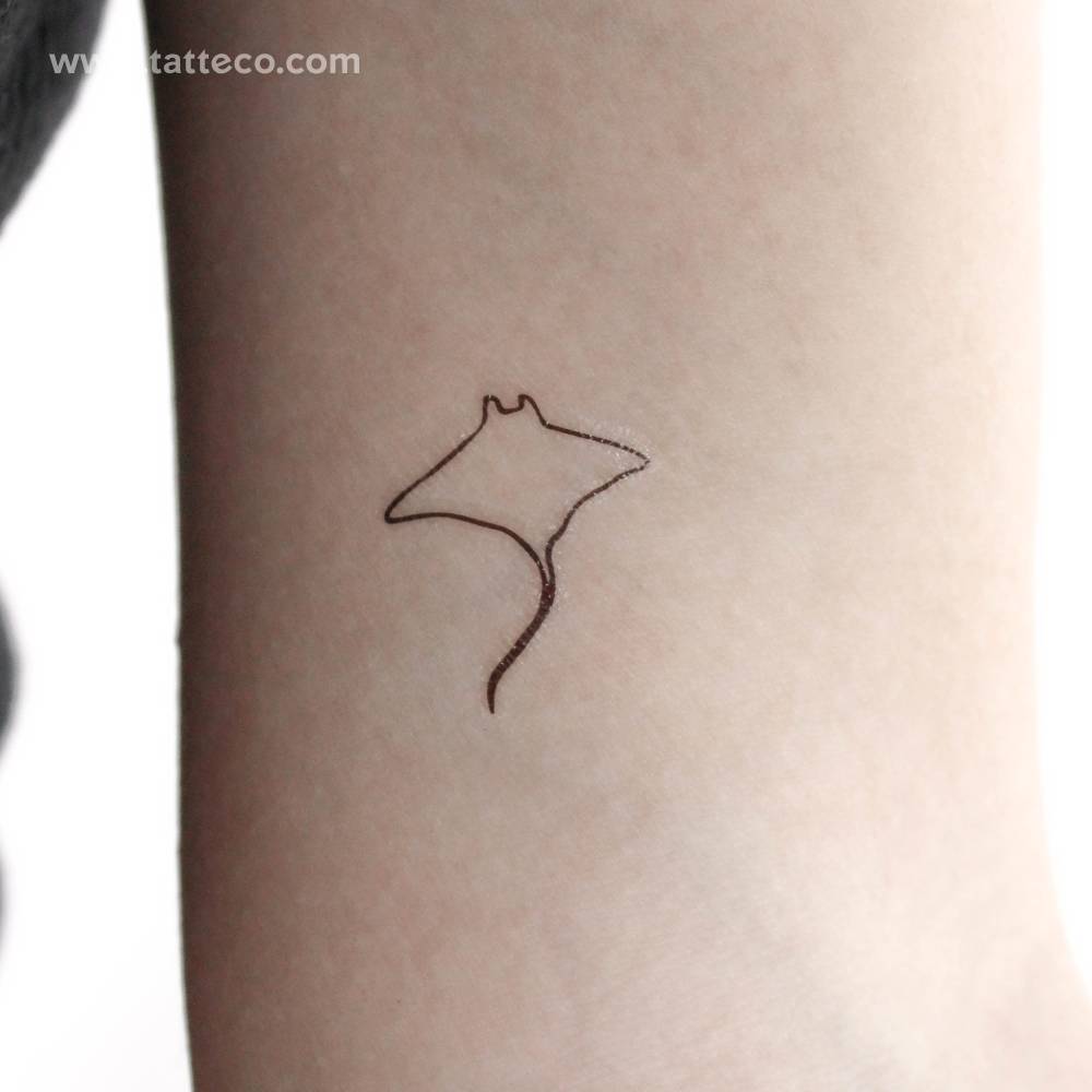 Small minimalistic manta ray temporary tattoo located on the inner arm.