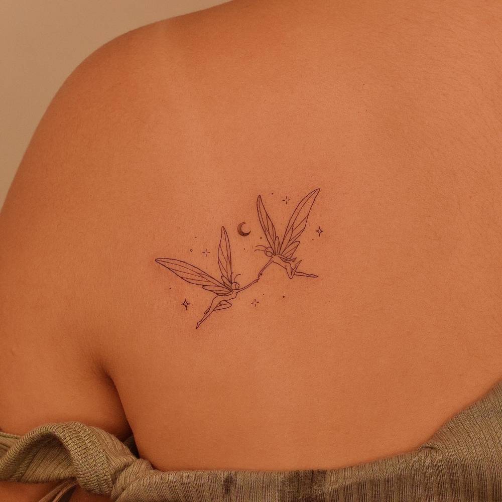 Fine line style fairies tattoo done on the shoulder blade.