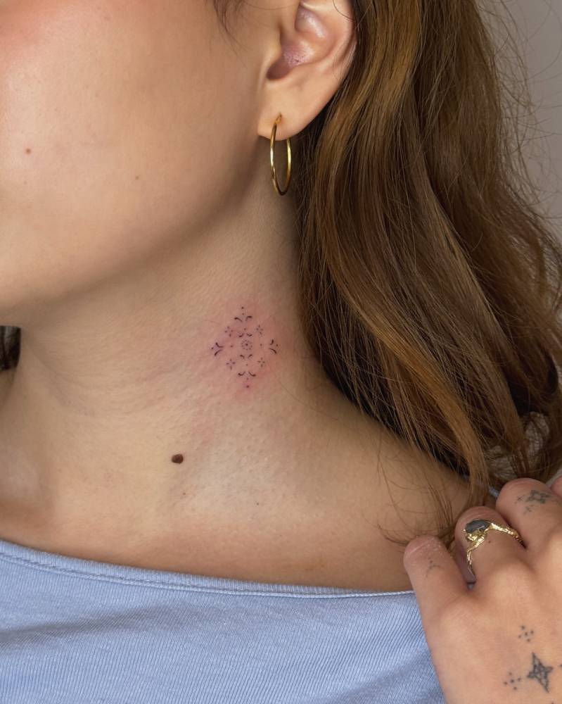 Ornamental design tattooed on the neck, fine line style.