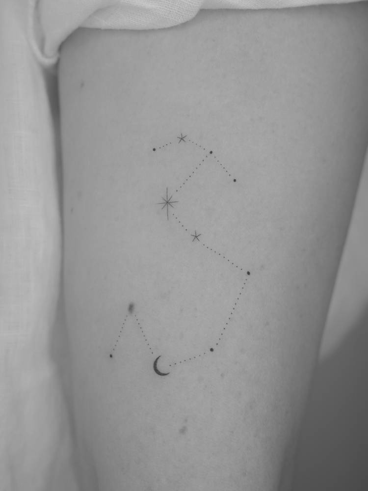 Scorpius constellation tattoo located on the upper arm.