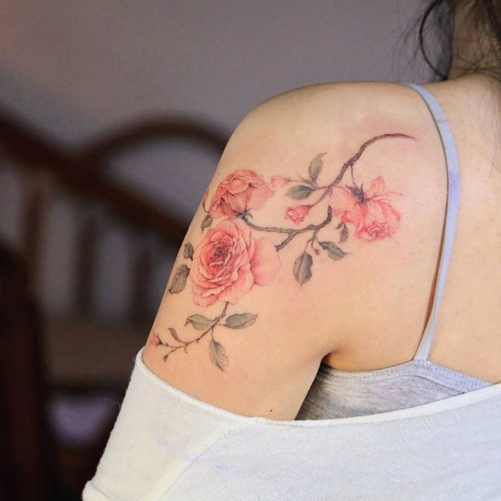 Watercolor style pink roses tattoo located on the shoulder blade.