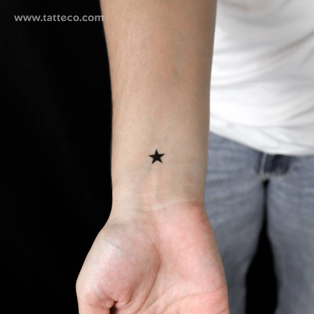 Minimalistic style black star semi-permanent tattoo.