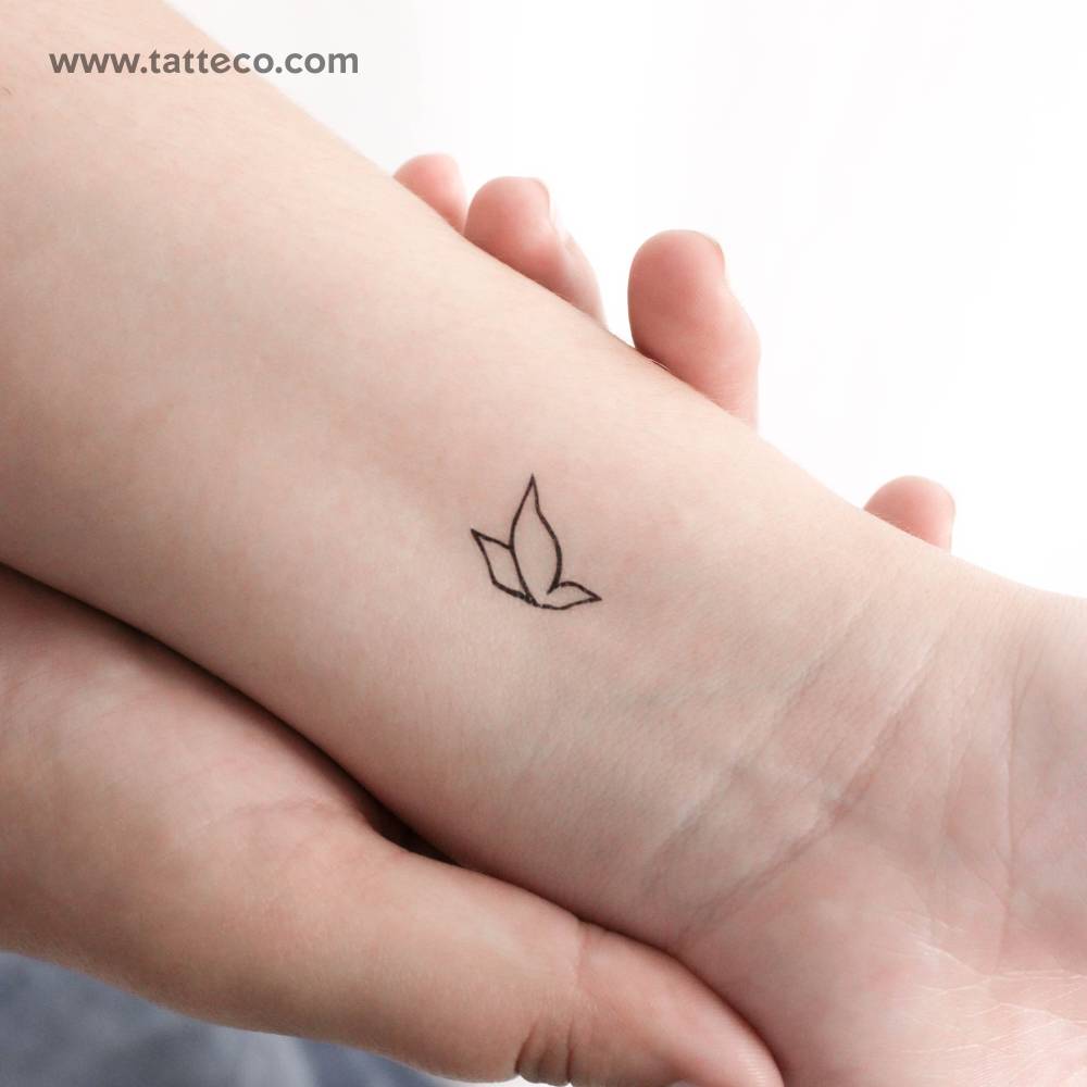Little minimalist flying butterfly temporary tattoo located on the wrist.