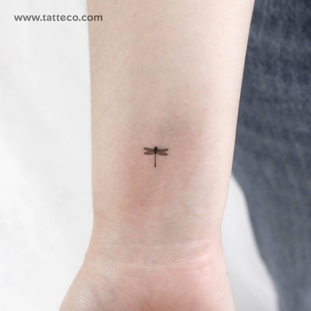 Tiny dragonfly temporary tattoo located on the wrist.