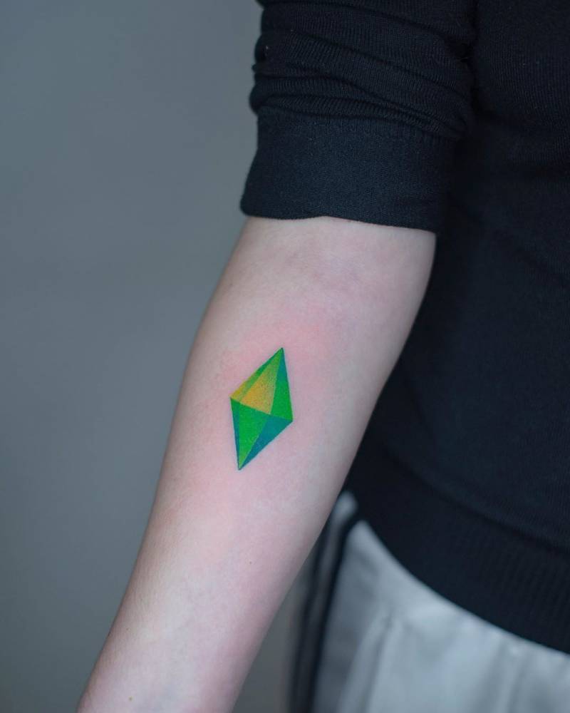 Hand poked style The Sims tattoo located on the inner forearm.