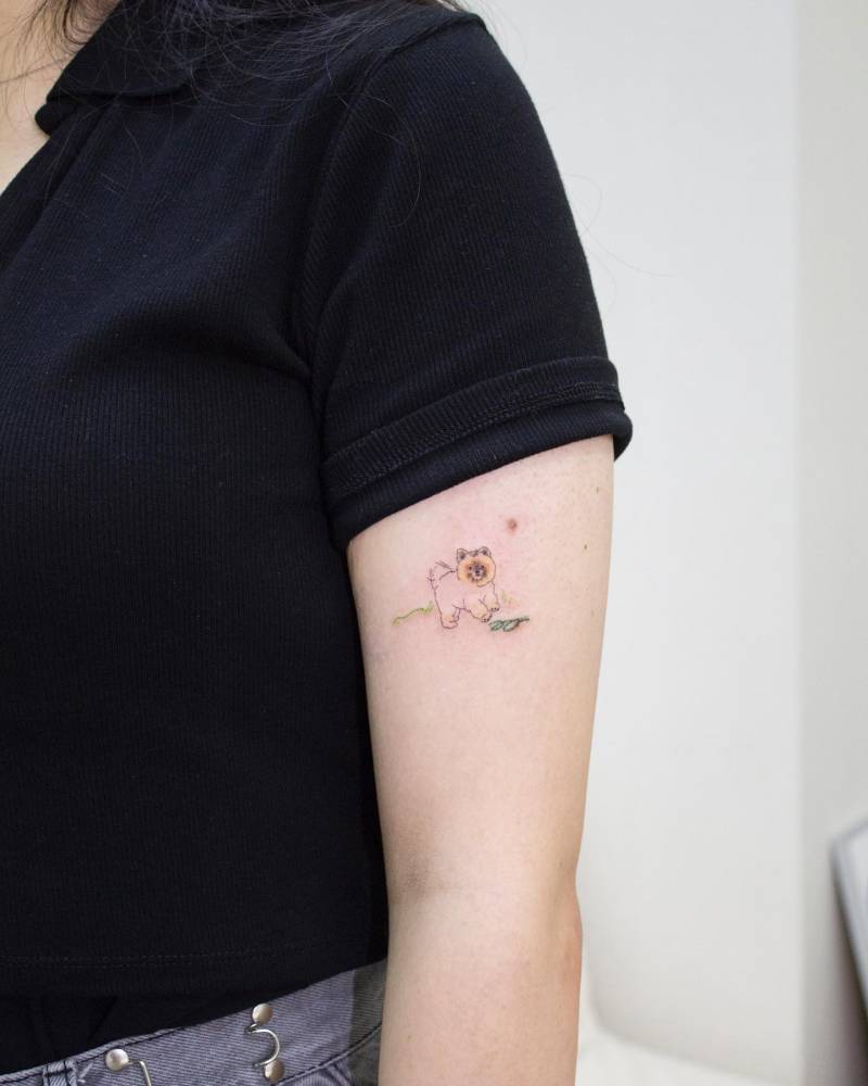 Illustrative style Shiba Inu tattoo located on the upper arm.