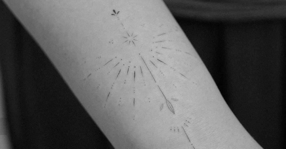 Fine line style ornamental tattoo located on the wrist.