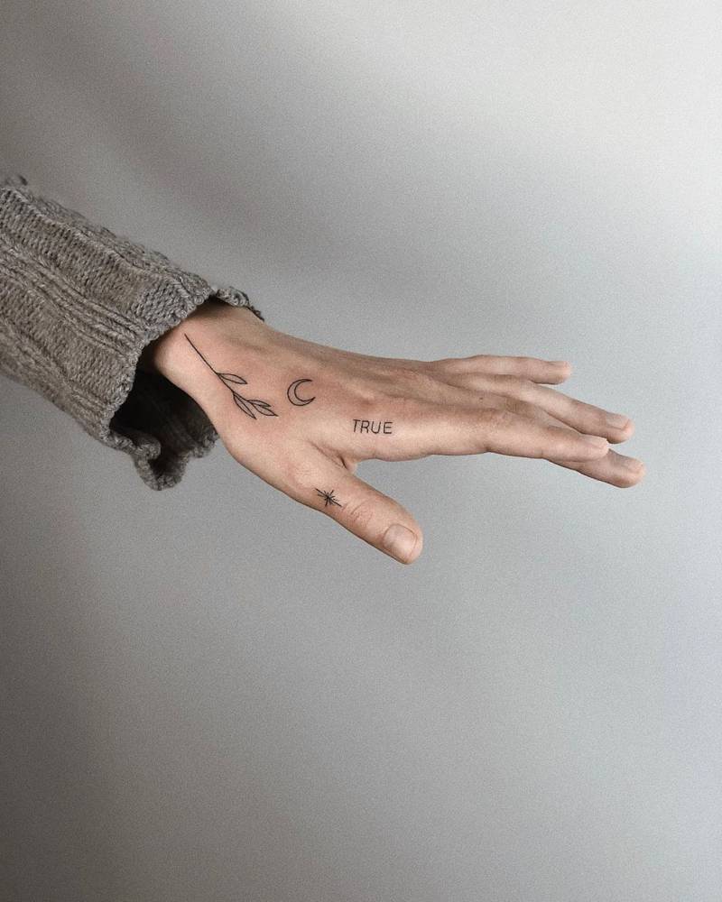 Hand-poked tattoos on hand and thumb