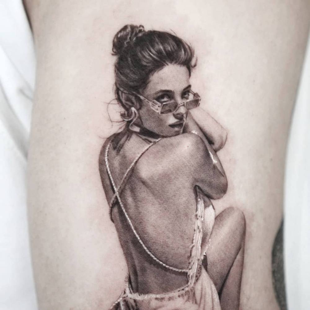 Woman tattooed on upper arm