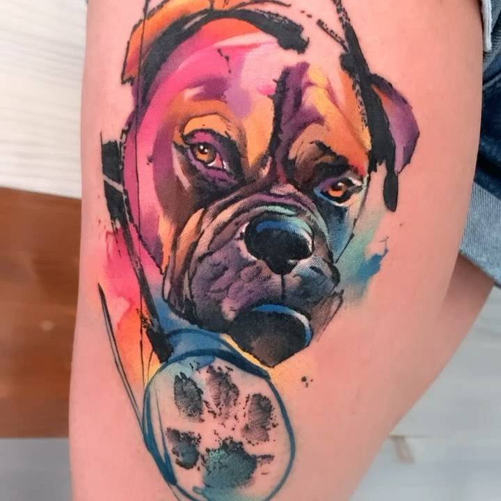 Watercolor style boxer portrait tattooed on the thigh.