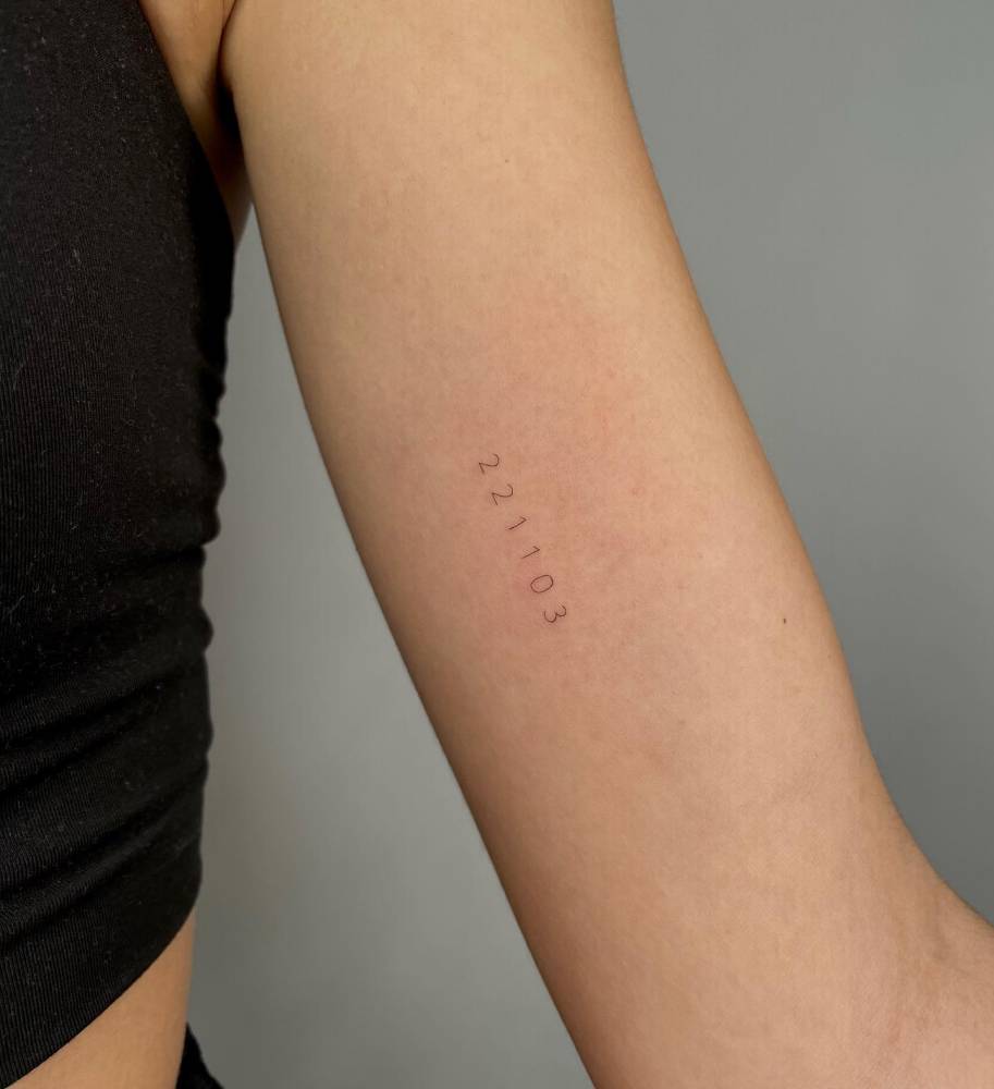 Date tattoo located on the inner arm.