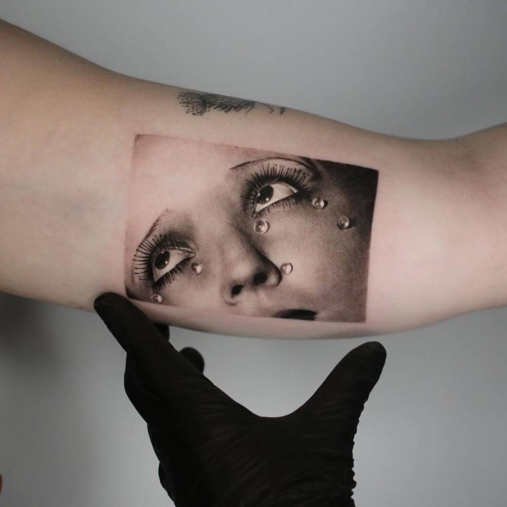 Micro-realistic Man Ray's Larmes de Verre tattoo on the inner arm.