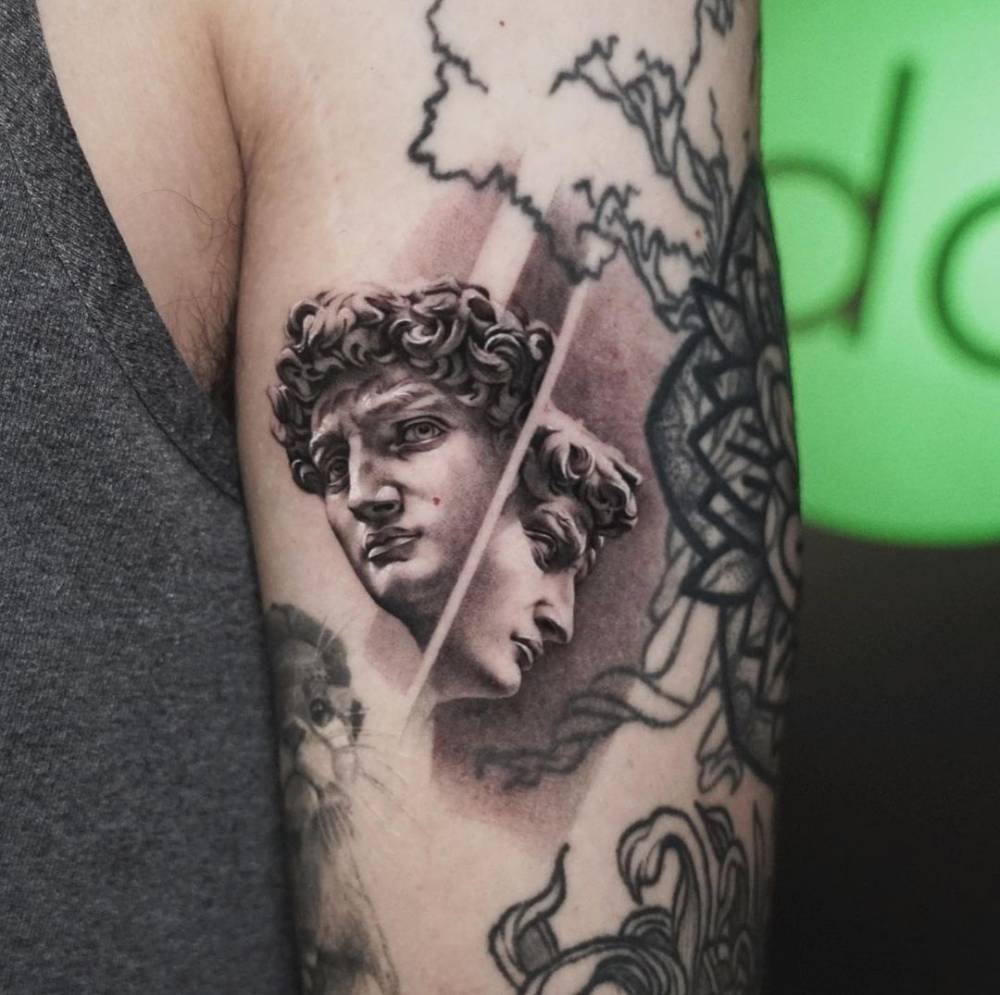 Micro-realistic David tattoo on the tricep.