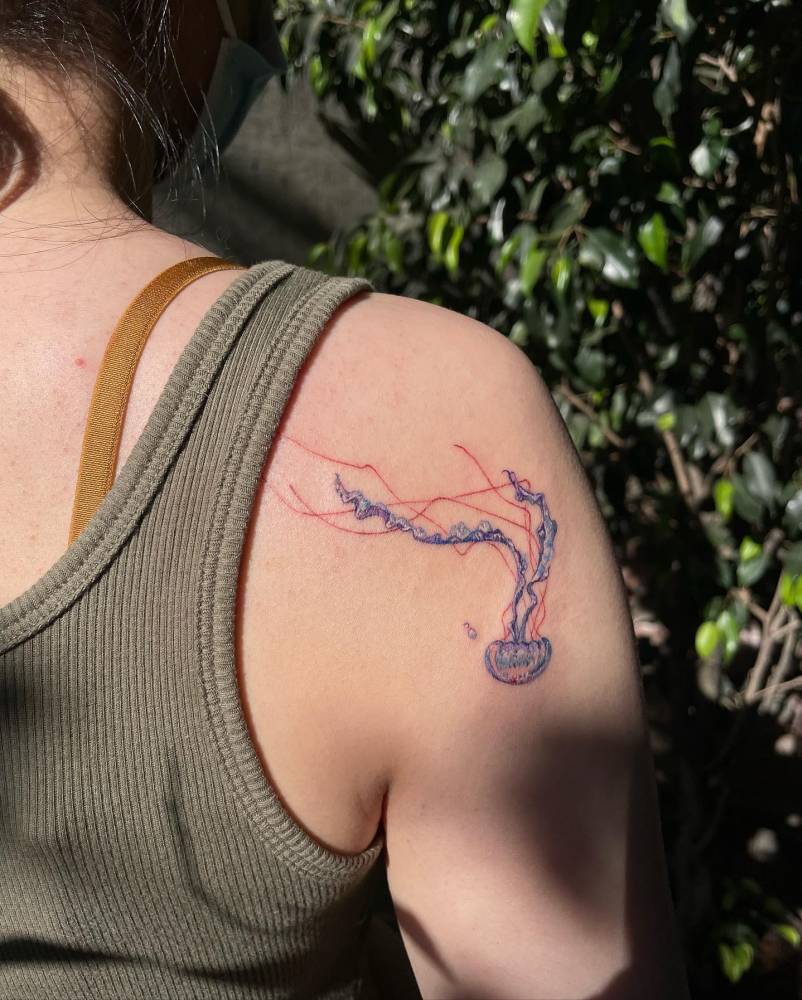 Watercolor jellyfish tattoo done on the shoulder blade.