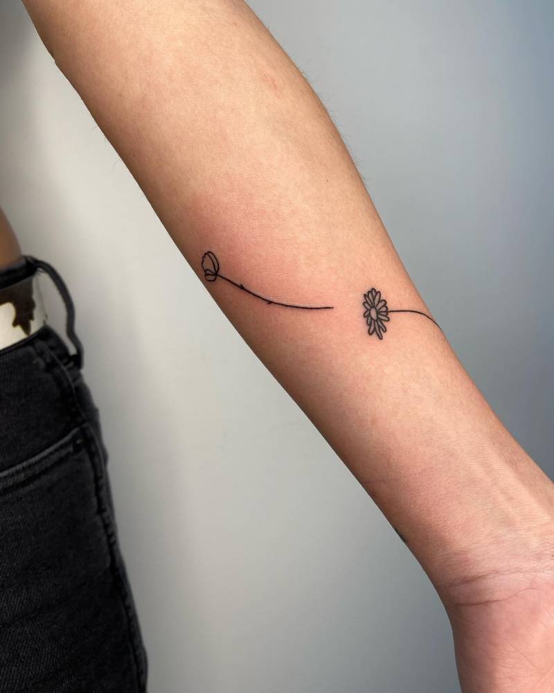 Minimalistic  flowers tattoo located on the inner forearm.