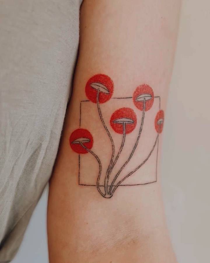 Fun mushrooms hand poked on the bicep.