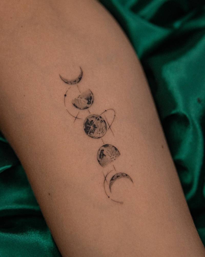 Micro-realistic style moon phases tattoo placed on the inner arm.