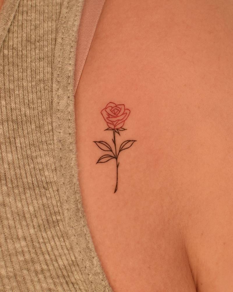 Fine line style red rose tattoo located on the shoulder.