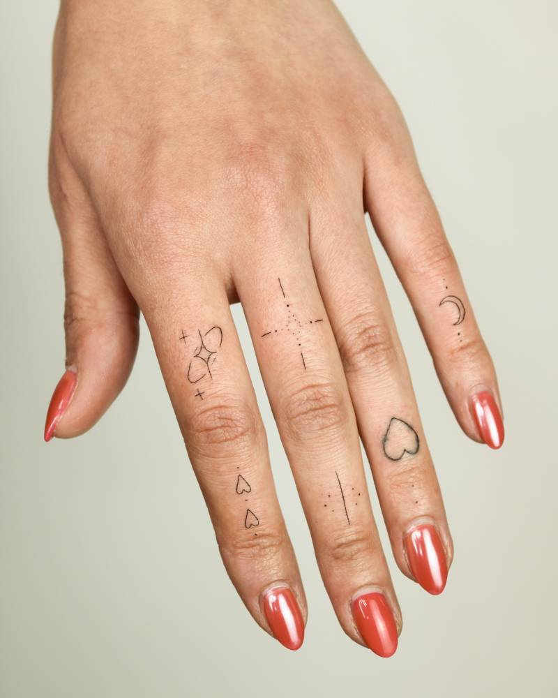 Fine line style ornamental finger composition tattoos.