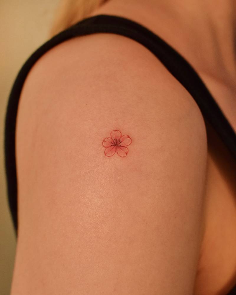 Illustrative style cherry blossom tattoo located on the shoulder.