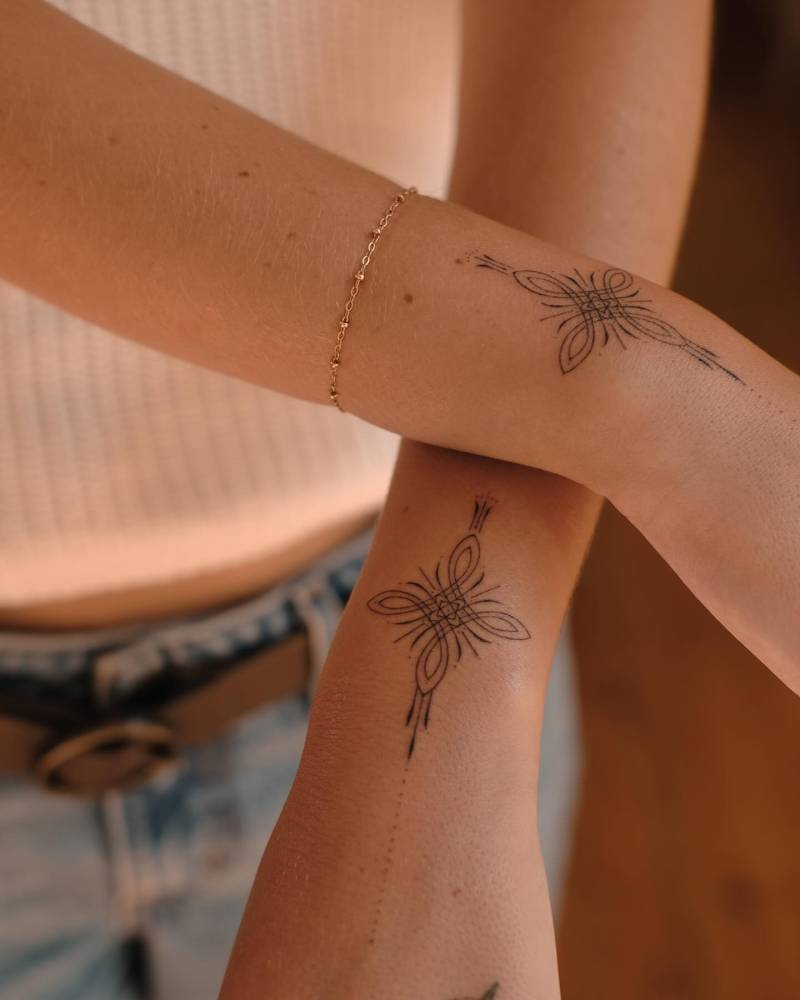 Individual matching ornaments tattooed on the wrists.