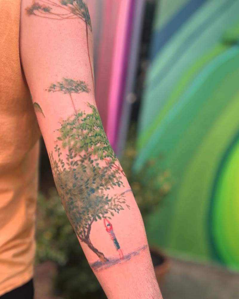 Tree and child tattoo located on the arm, watercolor style.