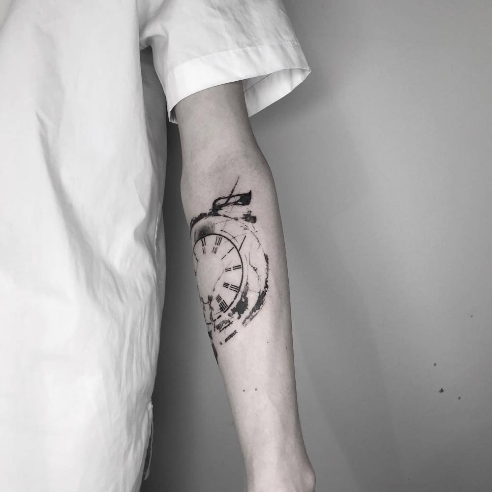 Blackwork style clock tattoo located on the inner forearm.