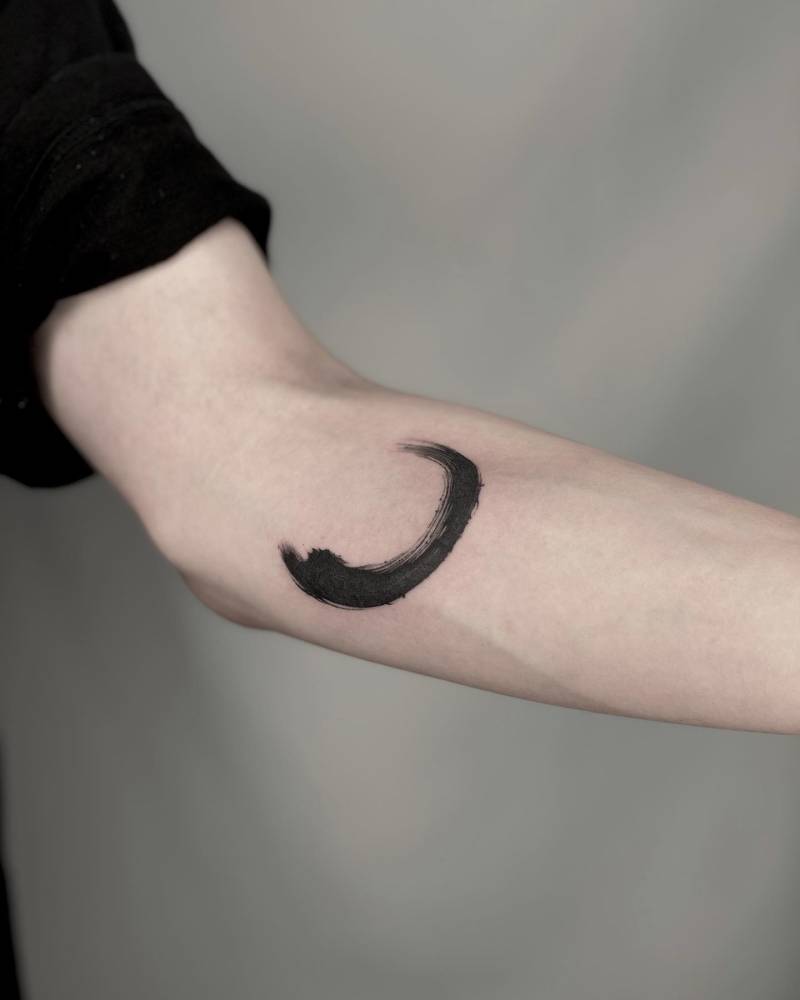 Brush stroke tattoo located on the inner forearm.
