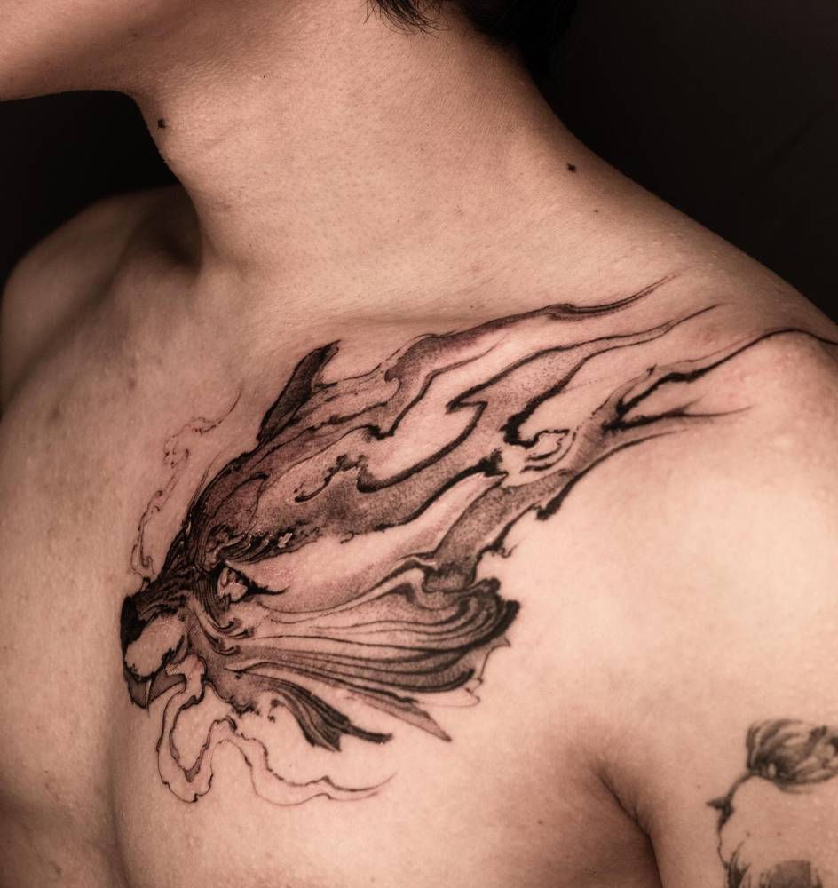 Wolf head tattoo located on the chest, blackwork style.