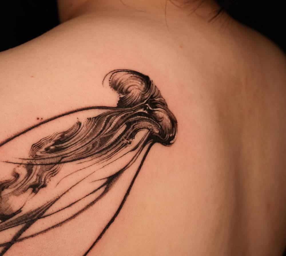 Jellyfish tattoo located on the shoulder blade, blackwork style.