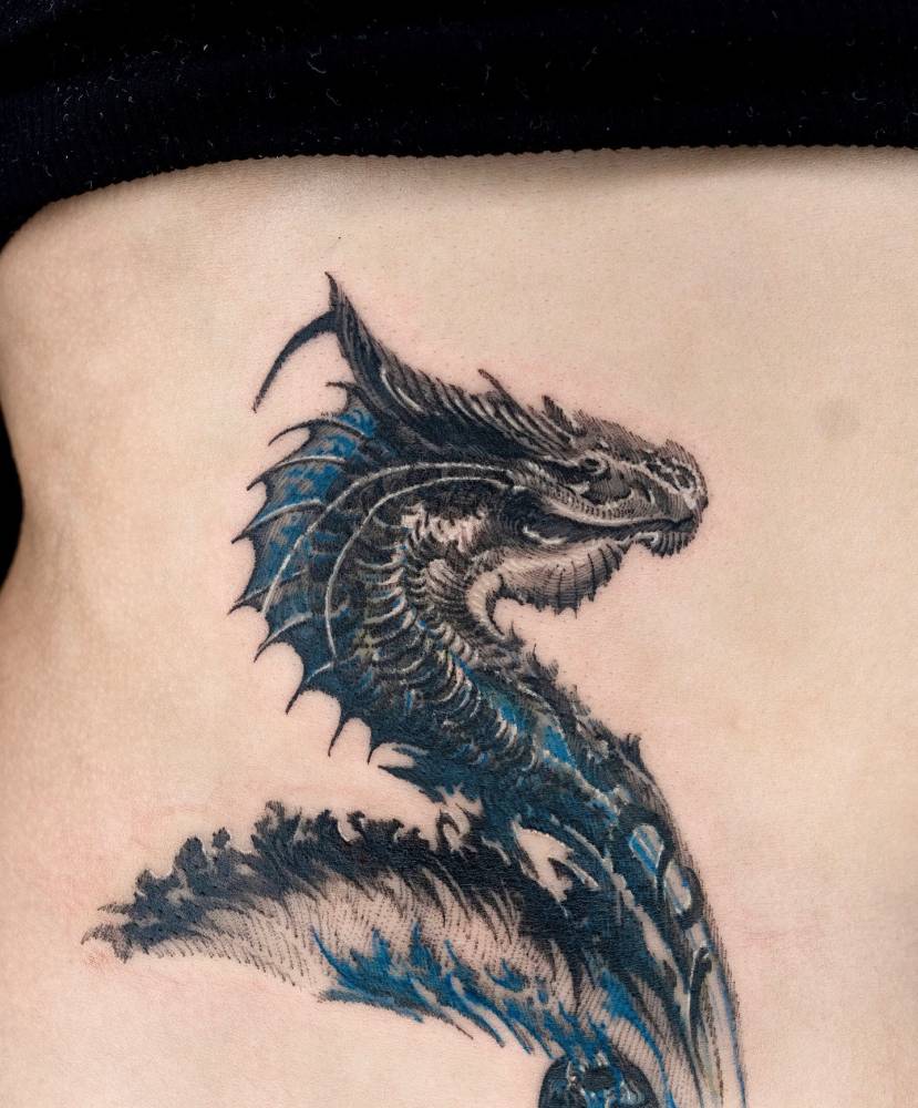 Illustrative style dragon tattoo done on the waist.