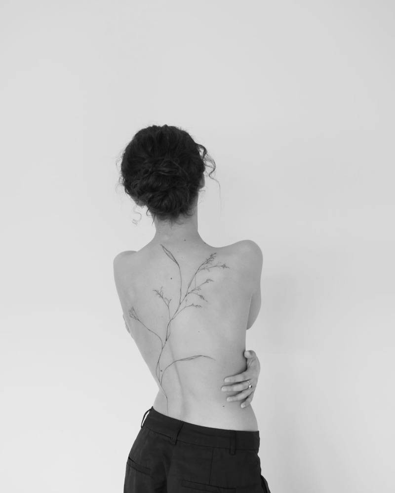 Baby's breath tattoo in fine line style located on the back.