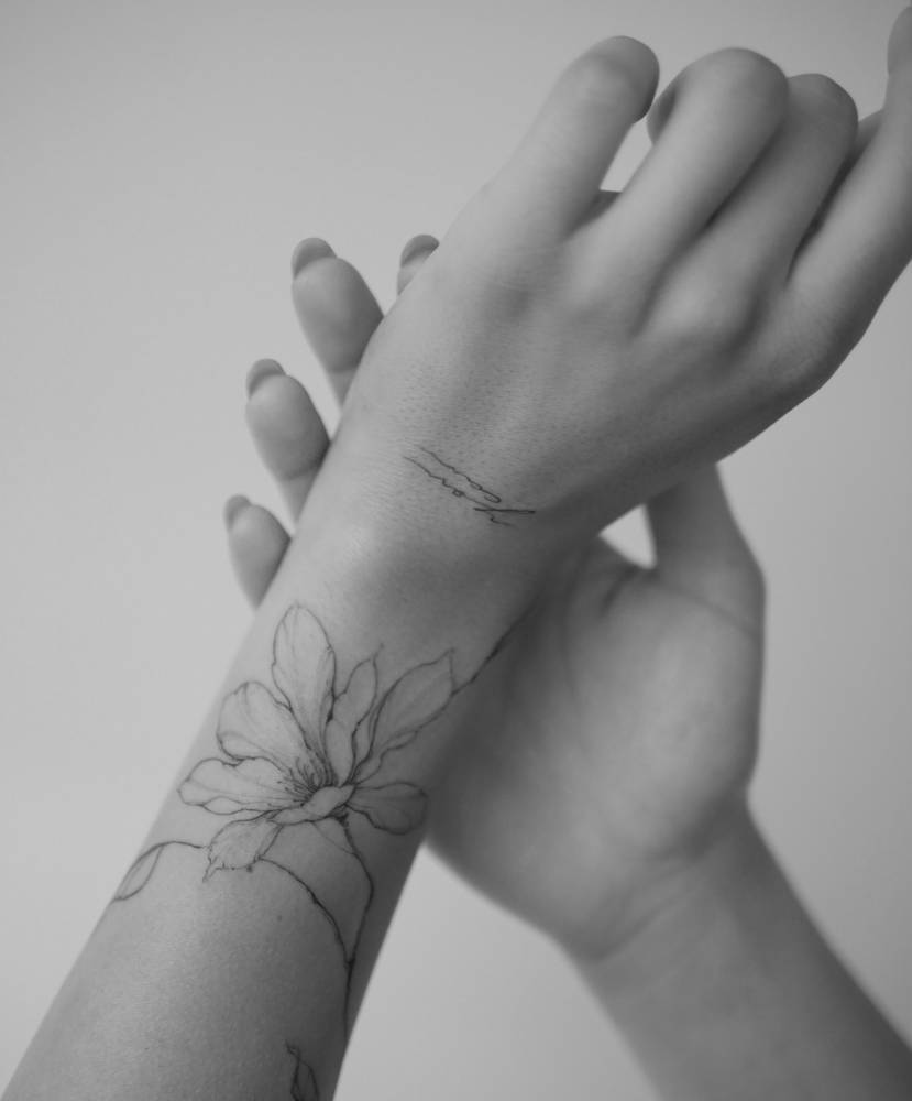 Magnolia flower tattoo located on the wrist.