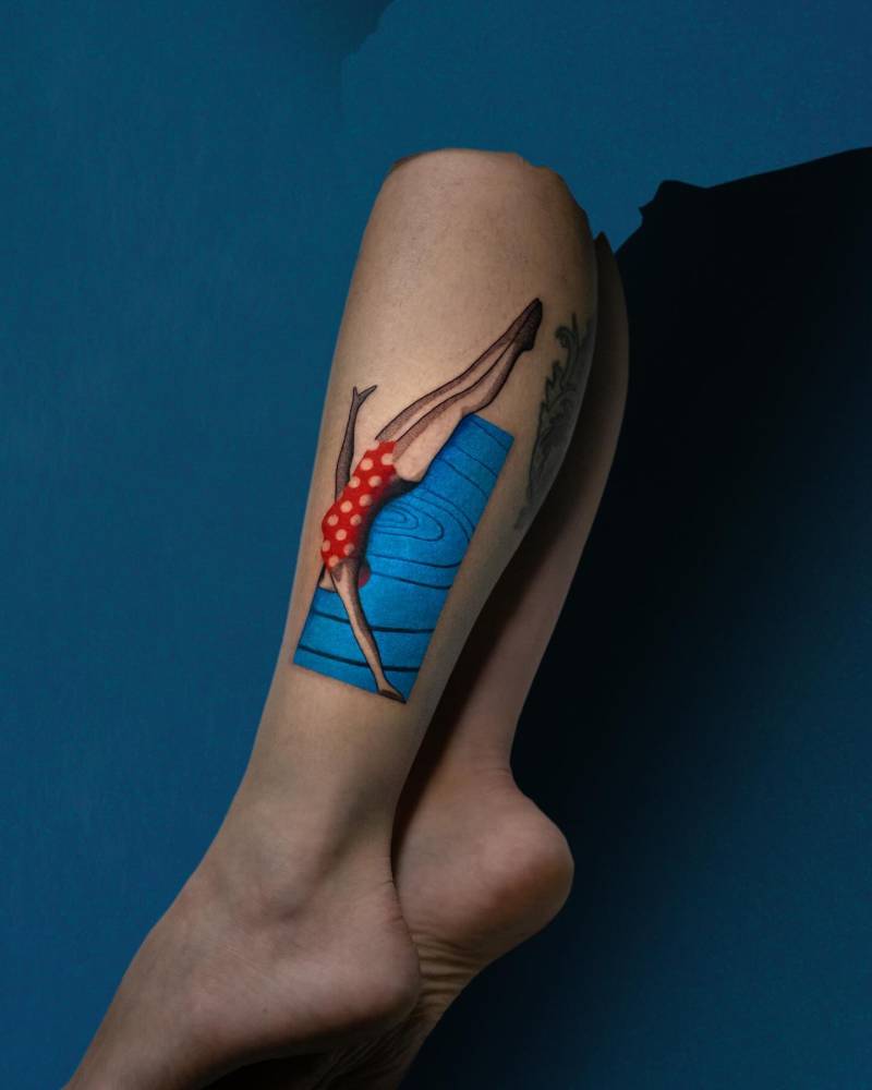 High diving tattoo in pop art style located on the shin.