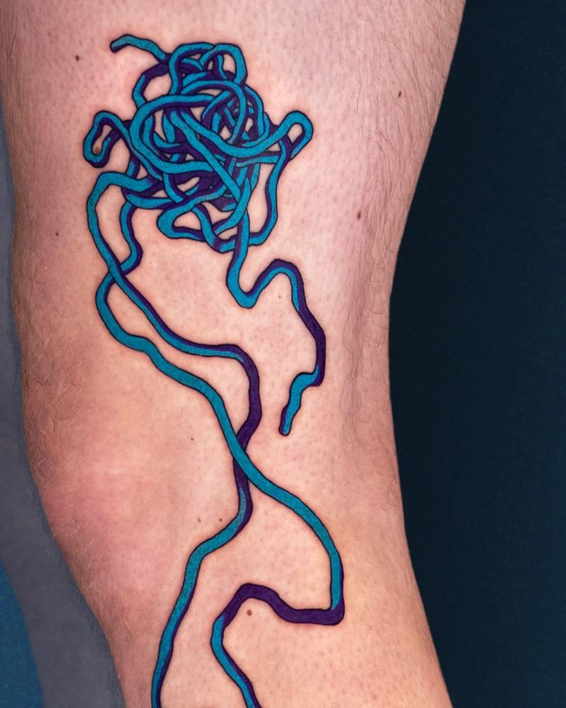 Wool yarn tattoo located on the leg, pop art style.
