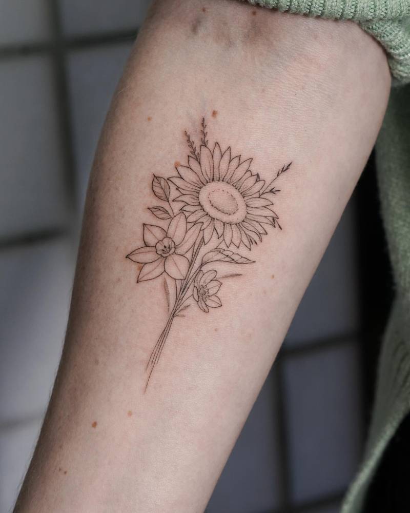 Flower bouquet tattoo located on the inner forearm.