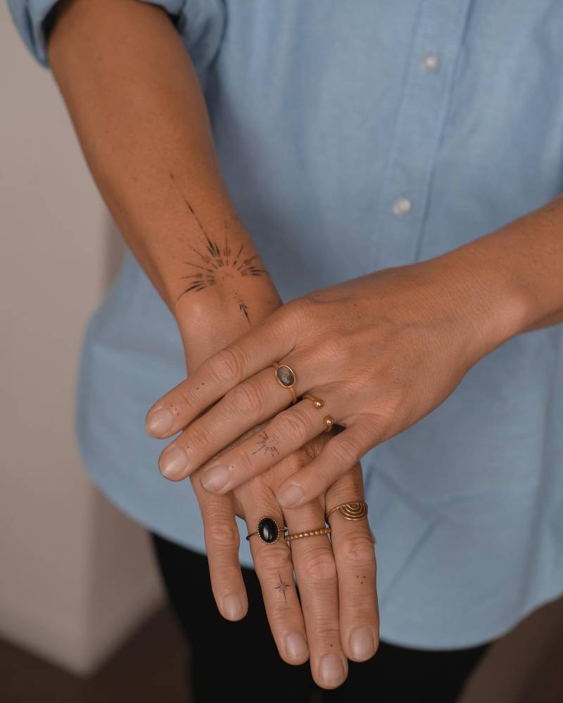 Hand poked ornamental tattoo placed on the wrist.